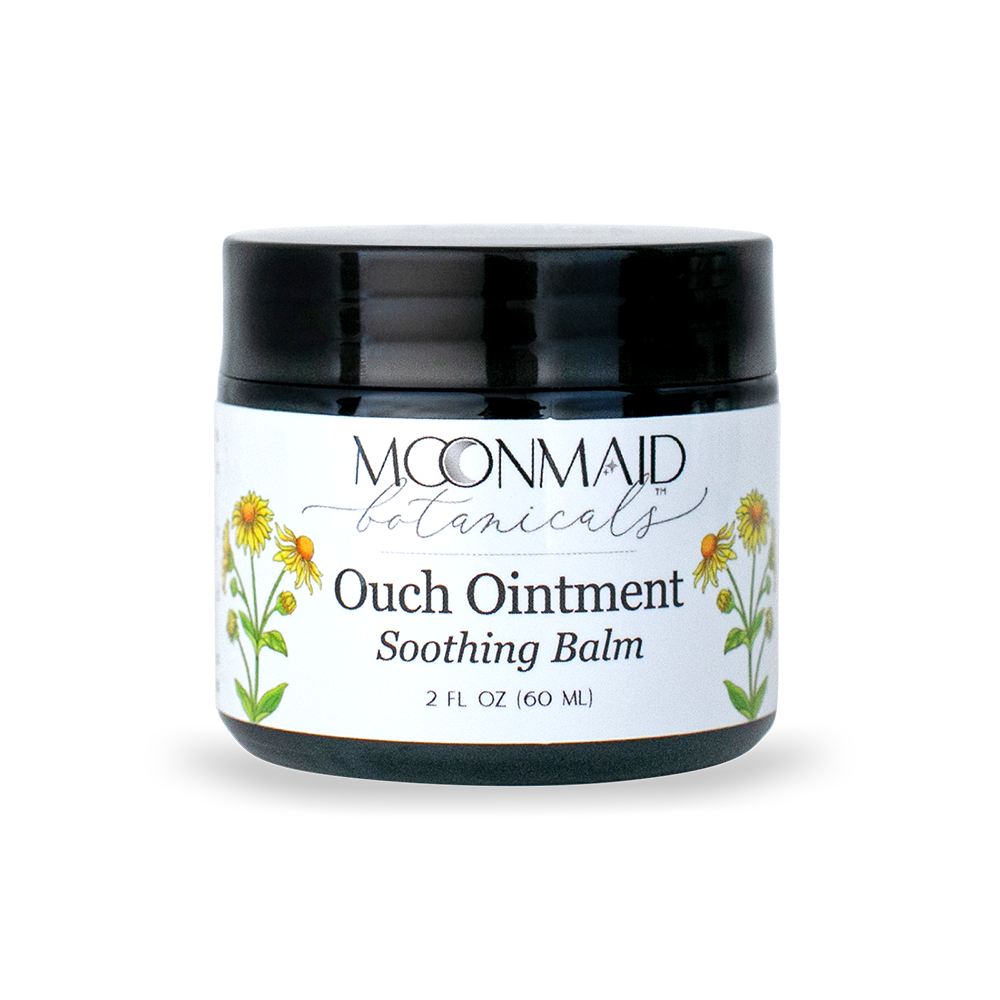 Front view of a closed jar of Moonmaid Botanicals Ouch Ointment Soothing Balm, decorated with yellow arnica or calendula flower graphics.