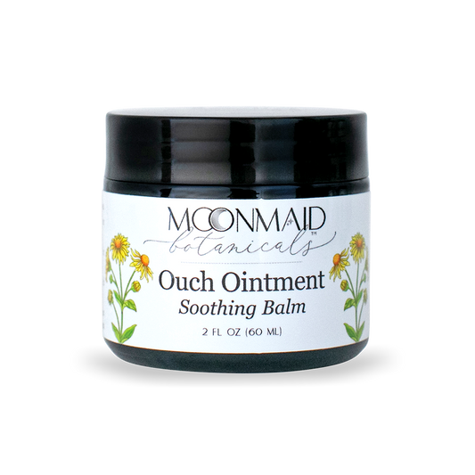 Front view of a closed jar of Moonmaid Botanicals Ouch Ointment Soothing Balm, decorated with yellow arnica or calendula flower graphics.