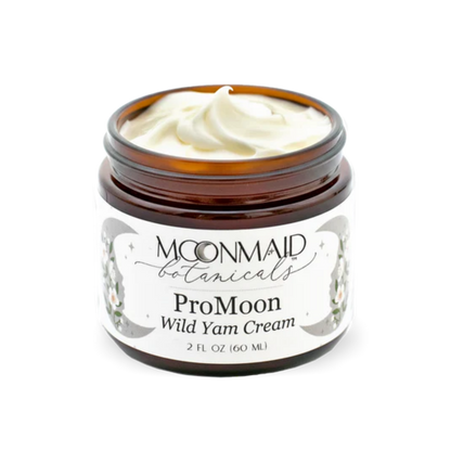 An open amber glass jar of MoonMaid Botanicals ProMoon Wild Yam Cream, revealing a thick, creamy white swirl of the product inside.