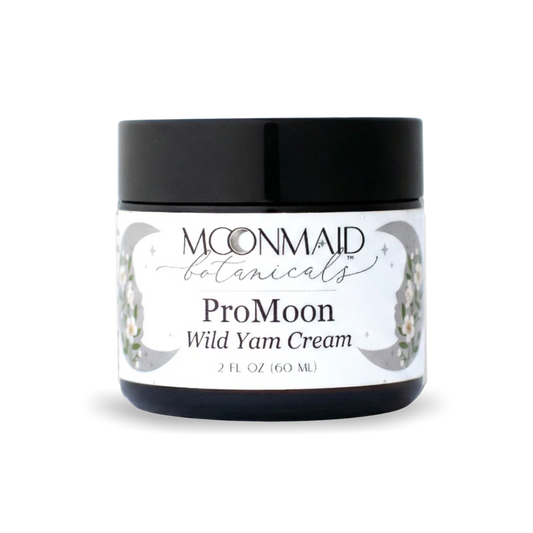 A 2 fl oz amber glass jar with a black screw-top lid featuring MoonMaid Botanicals ProMoon Wild Yam Cream against a solid dark background.