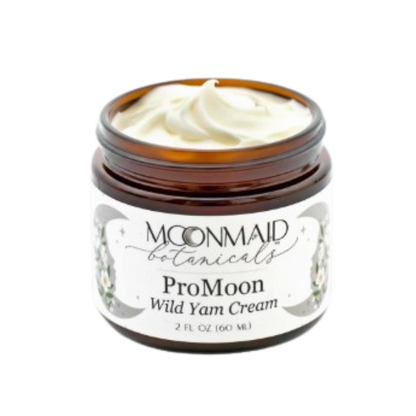 An angled close-up view of an open jar of Moonmaid Botanicals ProMoon Wild Yam Cream, highlighting its rich, whipped natural texture.